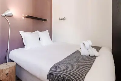 a bedroom with a large bed with white pillows at Le Balcon du Brevent - Central - Vue montagne in Chamonix-Mont-Blanc