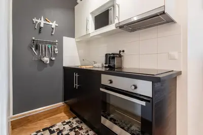 a kitchen with a counter top and a stove at Le Balcon du Brevent - Central - Vue montagne in Chamonix-Mont-Blanc