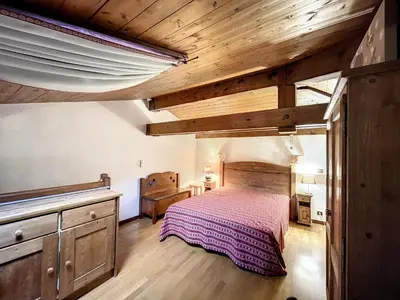 a bedroom with a bed and a wooden ceiling at Studio mezzanine au centre de Combloux avec parking - FR-1-560-123 in Combloux
