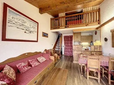 a living room with a couch and a table at Studio mezzanine au centre de Combloux avec parking - FR-1-560-123 in Combloux