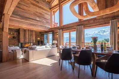 a living room with a table and a couch at Chalet 14 personnes I Luxe I Piscine & Sauna I Salle cinéma I Le Chalet Club in Combloux