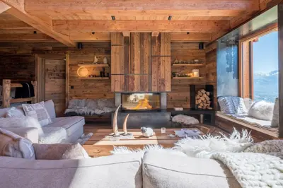 a living room with couches and a fireplace at Chalet 14 personnes I Luxe I Piscine & Sauna I Salle cinéma I Le Chalet Club in Combloux