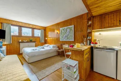 a kitchen and a bedroom with a bed in a room at Studio de Balme - Happy Rentals in Chamonix-Mont-Blanc
