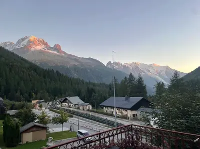 a train station with mountains in the background at 10 Bel-Alp in Chamonix-Mont-Blanc