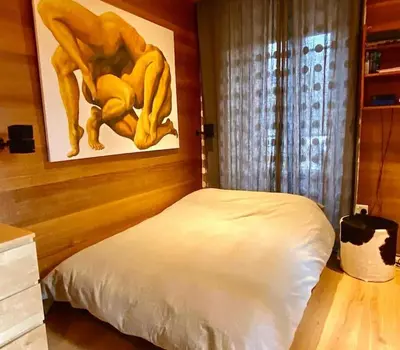a bedroom with a bed and a painting on the wall at 10 Bel-Alp in Chamonix-Mont-Blanc