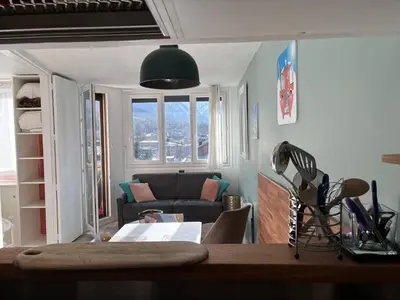 a living room with a couch and a table at Chamois blanc / Chamonix in Chamonix-Mont-Blanc