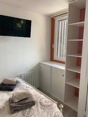 a bedroom with a bed and a window and shelves at Chamois blanc / Chamonix in Chamonix-Mont-Blanc