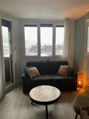 a living room with a couch and a table at Chamois blanc / Chamonix in Chamonix-Mont-Blanc