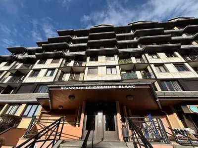 a tall building with the entrance to a building at Chamois blanc / Chamonix in Chamonix-Mont-Blanc