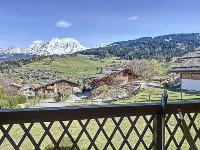 a view from a balcony of a village with mountains at Appartement 2 chambres avec parking et wifi à Combloux - FR-1-560-124 in Combloux