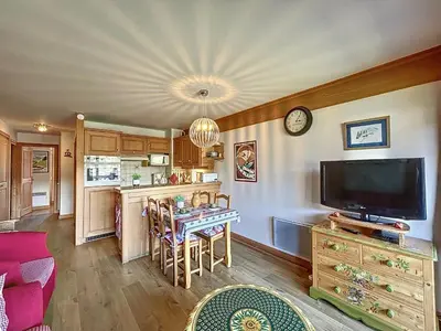 a living room with a tv and a kitchen at Appartement 2 chambres avec parking et wifi à Combloux - FR-1-560-124 in Combloux