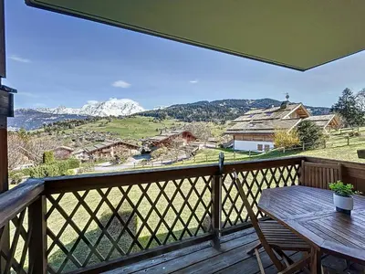 a balcony with a table and a view of a mountain at Appartement 2 chambres avec parking et wifi à Combloux - FR-1-560-124 in Combloux
