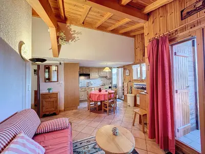 a living room with a table and a kitchen at Appartement avec garage proches ski bus à Combloux - FR-1-560-126 in Combloux