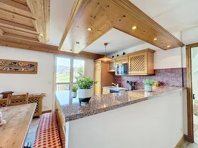 a kitchen with wooden ceilings and a large counter top at Chalet 9 personnes à Combloux, Mont Blanc - FR-1-560-125 in Combloux
