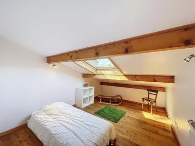 a attic bedroom with a bed and a skylight at Chalet 9 personnes à Combloux, Mont Blanc - FR-1-560-125 in Combloux