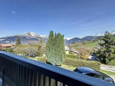 a car parked on a balcony with mountains in the background at Chalet 9 personnes à Combloux, Mont Blanc - FR-1-560-125 in Combloux