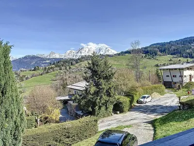 two cars parked on a road with mountains in the background at Chalet 9 personnes à Combloux, Mont Blanc - FR-1-560-125 in Combloux