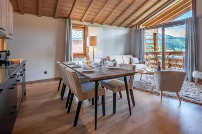 a kitchen and dining room with a table and chairs at Megève appartement 4 pièces résidence de standing in Megève
