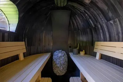 a room with two benches in a wooden igloo at Chalet Soleil Blanc au pied des pistes in Saint-Gervais-les-Bains