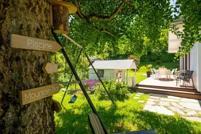 a garden with signs on the side of a tree at Chalet Soleil Blanc au pied des pistes in Saint-Gervais-les-Bains