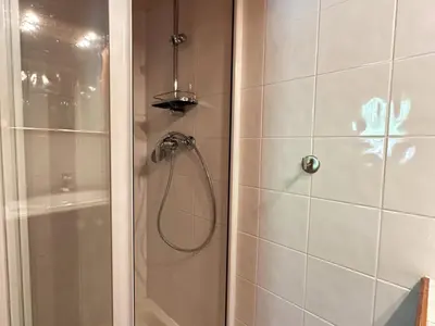 a shower with a shower head in a bathroom at Confortable Appartement T3 au Centre avec Animaux admis - FR-1-624-158 in Samoëns