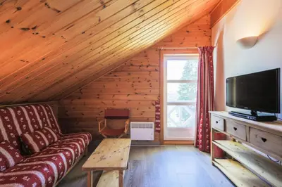 a living room with a couch and a tv at Les Chalets de Flaine Hameau - maeva Home - Chalet 4 Pièces 8 Personnes - Sélection MAE-3386 in Flaine