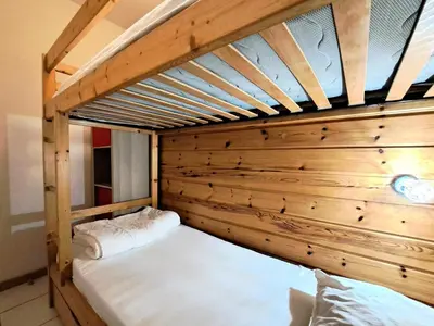 a bunk bed in a room with wooden walls at Les Chalets de Flaine Hameau - maeva Home - Chalet 3 Pièces 8 Personnes - Confort MAE-3392 in Flaine