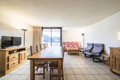 a living room with a table and chairs and a television at Résidence Pégase - maeva Home - Appartement 3 pièces 8 personnes Confort MAE-3481 in Flaine