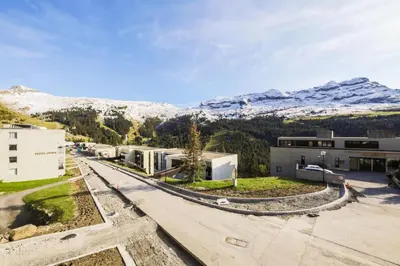 an aerial view of a building with snow covered mountains in the background at Résidence Pégase - maeva Home - Appartement 3 pièces 8 personnes Confort MAE-3481 in Flaine