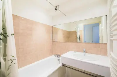a bathroom with a sink and a tub and a mirror at Résidence Pégase - maeva Home - Appartement 3 pièces 8 personnes Confort MAE-3481 in Flaine