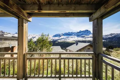 a view from the porch of a cabin with snow covered mountains at Résidence Refuge du Golf - maeva Home - Appartement 2 pièces 4 personnes Prestige MAE-3482 in Arâches-la-Frasse