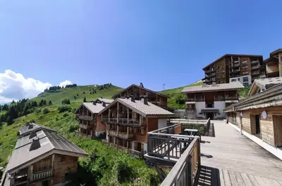 a group of wooden buildings on a hill at Résidence Refuge du Golf - maeva Home - Appartement 2 pièces 4 personnes Prestige MAE-3482 in Arâches-la-Frasse