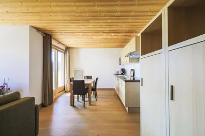 a kitchen and dining room with a table and chairs at Résidence Refuge du Golf - maeva Home - Appartement 2 pièces 4 personnes Prestige MAE-3482 in Arâches-la-Frasse