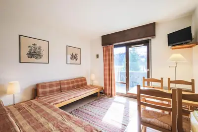 a bedroom with a bed and a couch and a table at Résidence Andromède - maeva Home - Appartement 2 pièces 6 personnes Confort MAE-3514 in Flaine