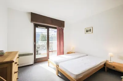 a bedroom with a bed and a large window at Résidence Andromède - maeva Home - Appartement 2 pièces 6 personnes Confort MAE-3514 in Flaine