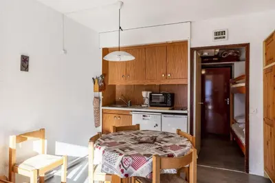 a small kitchen with a table and a microwave at Résidence Andromède - maeva Home - Studio 4 personnes Confort MAE-3516 in Flaine