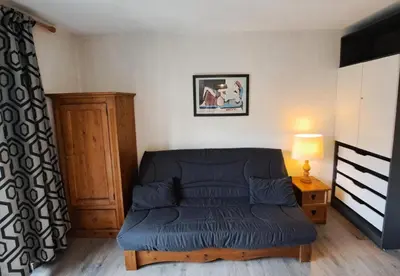 a living room with a blue couch in a room at Résidence Andromède - maeva Home - Studio 4 Personnes - Confort MAE-3649 in Flaine