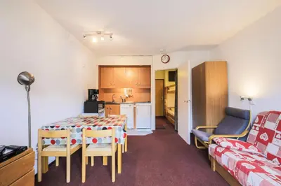 a room with a table and chairs and a kitchen at Résidence Andromède - maeva Home - Studio 4 Personnes - Confort MAE-3650 in Flaine