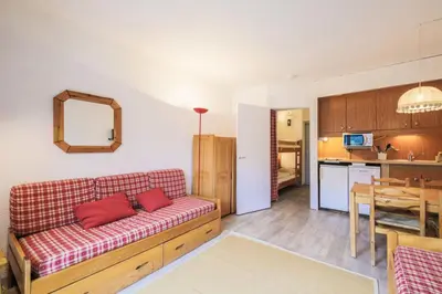 a living room with a couch and a kitchen at Résidence Andromède - maeva Home - Studio 4 Personnes - Confort MAE-3651 in Flaine
