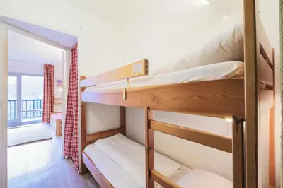 two bunk beds in a room with a window at Résidence Andromède - maeva Home - Studio 4 Personnes - Confort MAE-3651 in Flaine