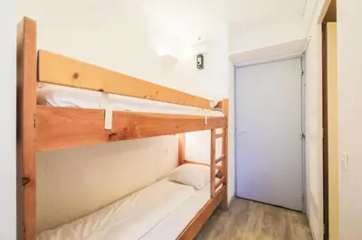 a couple of bunk beds in a room with a door at Résidence Andromède - maeva Home - Studio 4 Personnes - Confort MAE-3651 in Flaine