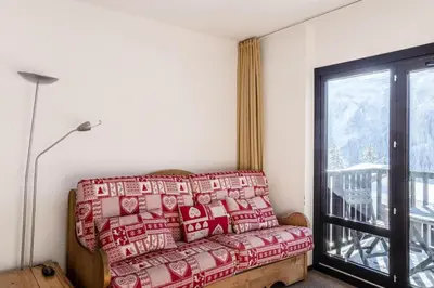 a living room with a couch and a window at Résidence Andromède - maeva Home - Studio 4 Personnes - Budget MAE-3652 in Flaine