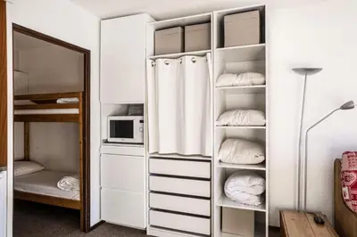 a closet with white cabinets and a mirror at Résidence Andromède - maeva Home - Studio 4 Personnes - Budget MAE-3652 in Flaine