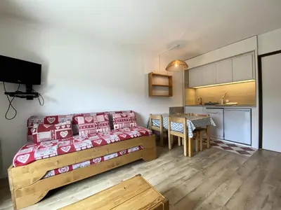 a bedroom with a bed and a table and a kitchen at Résidence Andromède - maeva Home - Studio 4 Personnes - Budget MAE-3652 in Flaine