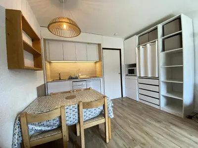 a kitchen with a table and chairs in a room at Résidence Andromède - maeva Home - Studio 4 Personnes - Budget MAE-3652 in Flaine