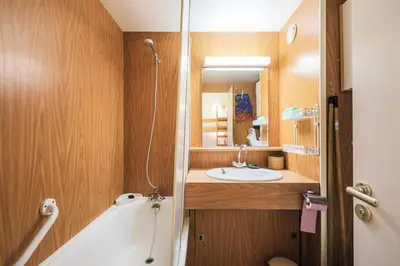 a bathroom with a bath tub and a sink at Résidence Andromède - maeva Home - Studio 4 Personnes - Confort MAE-3653 in Flaine
