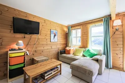 a living room with a couch and a tv at Les Chalets de Flaine Hameau - maeva Home - Chalet 3 Pièces 8 Personnes - Confort MAE-3654 in Flaine