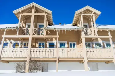 a wooden house with snow on the porch at Les Chalets de Flaine Hameau - maeva Home - Chalet 3 Pièces 8 Personnes - Confort MAE-3654 in Flaine