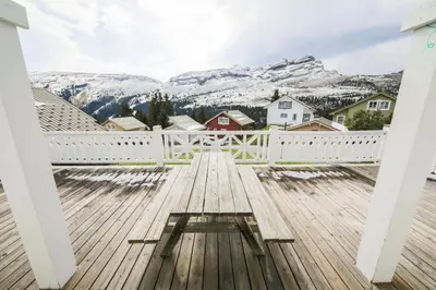 a wooden deck with a view of mountains at Les Chalets de Flaine Hameau - maeva Home - Chalet 5 Pièces 8 Personnes - Prestige MAE-3655 in Flaine