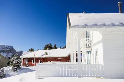 a white house with a white fence in the snow at Les Chalets de Flaine Hameau - maeva Home - Chalet 5 Pièces 8 Personnes - Prestige MAE-3655 in Flaine